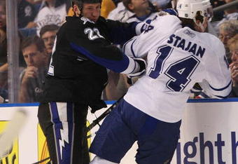 TAMPA, FL - FEBRUARY 12: Marek Malik #22 of the Tampa Bay Lightning hits Matt Stajan #14 the Toronto Maple Leafs on February 12, 2009 at the St. Pete Times Forum in Tampa, Florida. (Photo by Bruce Bennett/Getty Images)