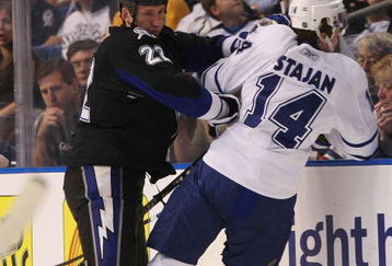 TAMPA, FL - FEBRUARY 12: Marek Malik #22 of the Tampa Bay Lightning hits Matt Stajan #14 the Toronto Maple Leafs on February 12, 2009 at the St. Pete Times Forum in Tampa, Florida. (Photo by Bruce Bennett/Getty Images)