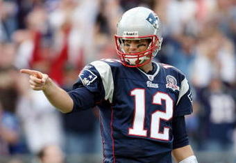 FOXBORO, MA - OCTOBER 04:  Tom Brady #12 of the New England Patriots celebrates Randy Moss' touchdown catch against the Baltimore Ravens on October 4, 2009 at Gillette Stadium in Foxboro, Massachusetts. The Patriots defeated the Ravens 27-21.  (Photo by Elsa/Getty Images)