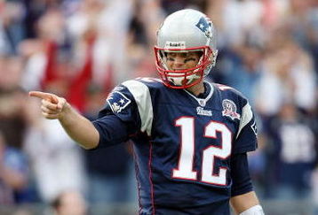 FOXBORO, MA - OCTOBER 04:  Tom Brady #12 of the New England Patriots celebrates Randy Moss' touchdown catch against the Baltimore Ravens on October 4, 2009 at Gillette Stadium in Foxboro, Massachusetts. The Patriots defeated the Ravens 27-21.  (Photo by Elsa/Getty Images)
