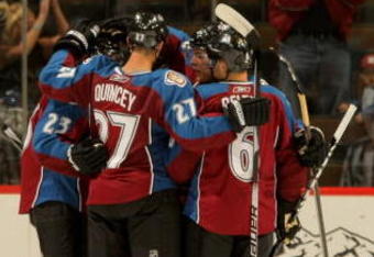 DENVER - SEPTEMBER 23:  The Colorado Avalanche celebrate a second-period goal by Milan Hejduk #23 to give the Avs a 2-0 lead as Peter Harrold #5 of the Los Angeles Kings skates away during preseason NHL action at the Pepsi Center on September 23, 2009 in Denver, Colorado.  (Photo by Doug Pensinger/Getty Images)