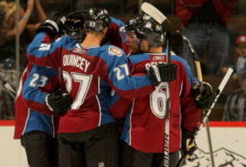 DENVER - SEPTEMBER 23:  The Colorado Avalanche celebrate a second-period goal by Milan Hejduk #23 to give the Avs a 2-0 lead as Peter Harrold #5 of the Los Angeles Kings skates away during preseason NHL action at the Pepsi Center on September 23, 2009 in Denver, Colorado.  (Photo by Doug Pensinger/Getty Images)