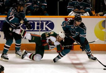 SAN JOSE, CA - OCTOBER 10:  Patrick Marleau #12 and Manny Malhotra #27 of the San Jose Sharks and Martin Havlat #14 of the Minnesota Wild go for the puck at HP Pavilion on October 10, 2009 in San Jose, California.  (Photo by Ezra Shaw/Getty Images)