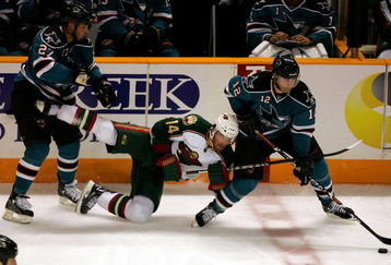 SAN JOSE, CA - OCTOBER 10:  Patrick Marleau #12 and Manny Malhotra #27 of the San Jose Sharks and Martin Havlat #14 of the Minnesota Wild go for the puck at HP Pavilion on October 10, 2009 in San Jose, California.  (Photo by Ezra Shaw/Getty Images)
