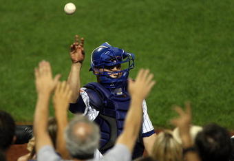 NEW YORK - AUGUST 19:  Omir Santos #9 of the New York Mets throws a ball to the fans after an inning against the Atlanta Braves on August 19, 2009 at Citi Field in the Flushing neighborhood of the Queens borough of New York City.  (Photo by Jim McIsaac/Getty Images)