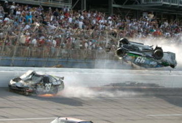 TALLADEGA, AL - APRIL 26:  Carl Edwards, driver of the #99 Claritin Ford, goes airborne as Ryan Newman, driver of the #39 Steweart-Haas Racing Chevrolet suffers damage and Dale Earnhardt Jr., driver of the #88 National Guard / AMP Energy Chevrolet drives at the conclusion of the NASCAR Sprint Cup Series Aaron's 499 at Talladega Superspeedway on April 26, 2009 in Talladega, Alabama.  (Photo by Jerry Markland/Getty Images for NASCAR)