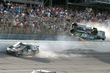 TALLADEGA, AL - APRIL 26:  Carl Edwards, driver of the #99 Claritin Ford, goes airborne as Ryan Newman, driver of the #39 Steweart-Haas Racing Chevrolet suffers damage and Dale Earnhardt Jr., driver of the #88 National Guard / AMP Energy Chevrolet drives at the conclusion of the NASCAR Sprint Cup Series Aaron's 499 at Talladega Superspeedway on April 26, 2009 in Talladega, Alabama.  (Photo by Jerry Markland/Getty Images for NASCAR)