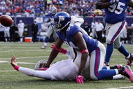EAST RUTHERFORD, NJ - OCTOBER 11: Mathias Kiwanuka #94 of the New York Giants forces a fumble against JaMarcus Russell #2 of the Oakland Raiders on October 11, 2009 at Giants Stadium in East Rutherford, New Jersey. The Giants defeated the Raiders 44-7. (Photo by Jim McIsaac/Getty Images)