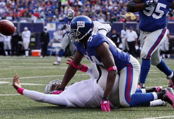 EAST RUTHERFORD, NJ - OCTOBER 11:  Mathias Kiwanuka #94 of the New York Giants forces a fumble against JaMarcus Russell #2 of the Oakland Raiders on October 11, 2009 at Giants Stadium in East Rutherford, New Jersey. The Giants defeated the Raiders 44-7.  (Photo by Jim McIsaac/Getty Images)