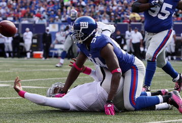 EAST RUTHERFORD, NJ - OCTOBER 11:  Mathias Kiwanuka #94 of the New York Giants forces a fumble against JaMarcus Russell #2 of the Oakland Raiders on October 11, 2009 at Giants Stadium in East Rutherford, New Jersey. The Giants defeated the Raiders 44-7.  (Photo by Jim McIsaac/Getty Images)