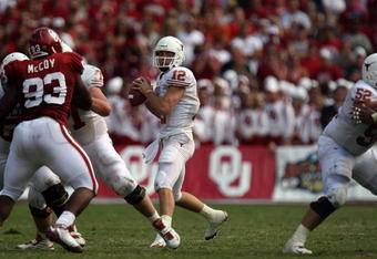 DALLAS - OCTOBER 11:  Quarterback Colt McCoy #12 of the Texas Longhorns drops back to pass against the Oklahoma Sooners during the Red River Rivalry at the Cotton Bowl on October 11, 2008 in Dallas, Texas.  The Longhorns defeated the Sooners 45-35.  (Photo by Ronald Martinez/Getty Images)