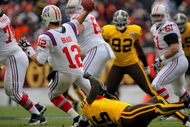 DENVER - OCTOBER 11:  Quarterback Tom Brady #12 of the New England Patriots gets a pass off to avoid a sack by linebacker D.J. Williams #55 of the Denver Broncos during NFL action at Invesco Field at Mile High on October 11, 2009 in Denver, Colorado.  (Photo by Doug Pensinger/Getty Images)