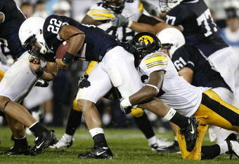 STATE COLLEGE, PA - SEPTEMBER 26:  Evan Royster #22 of the Penn State Nittnay Lions is tackled by Jeremiha Hunter #42 of the Iowa Hawkeye's on September 26, 2009 at Beaver Stadium in State College, Pennsylvania. (Photo by Gregory Shamus/Getty Images)