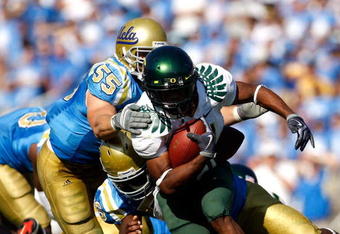 PASADENA, CA. - OCTOBER 10:  Kenjon Barner #24 of the Oregon Ducks runs the ball in the Fourth Quarter as Korey Bosworth #55 tackles him on October 10, 2009 at the Rosebowl in Pasadena, California.  (Photo by Jacob De golish/Getty Images)