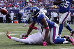 EAST RUTHERFORD, NJ - OCTOBER 11:  Mathias Kiwanuka #94 of the New York Giants forces a fumble against JaMarcus Russell #2 of the Oakland Raiders on October 11, 2009 at Giants Stadium in East Rutherford, New Jersey. The Giants defeated the Raiders 44-7.  (Photo by Jim McIsaac/Getty Images)
