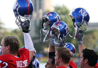 LAWRENCE, KS - SEPTEMBER 22:   Kansas Jayhawk players hoist their helmets as the campus looms in the background prior to the start of the game against the Florida International Golden Panthers on September 22, 2007 at Memorial Stadium in Lawrence, Kansas.  (Photo by Jamie Squire/Getty Images)