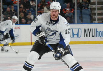 UNIONDALE, NY - APRIL 04: Ryan Malone #12 of the Tampa Bay Lightning moves the puck against the New York Islanders in a National Hockey League game at Nassau Coliseum on April 4, 2009 in Uniondale, New York. (Photo by Paul Bereswill/Getty Images)