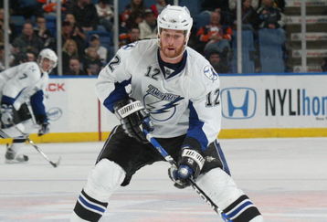 UNIONDALE, NY - APRIL 04: Ryan Malone #12 of the Tampa Bay Lightning moves the puck against the New York Islanders in a National Hockey League game at Nassau Coliseum on April 4, 2009 in Uniondale, New York. (Photo by Paul Bereswill/Getty Images)