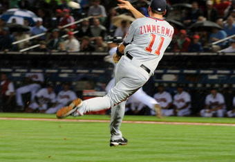 ATLANTA - APRIL 10: Third baseman Ryan Zimmerman #11 of the Washington Nationals fields a short hit and throws to first base for an out against the Atlanta Braves April 10, 2009 at Turner Field in Atlanta, Georgia.  (Photo by Al Messerschmidt/Getty Images)