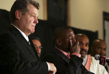 LAS VEGAS - NOVEMBER 04:  Promoter Dan Goosen (L) and Leonard Ellerbe (R) look on as Floyd Mayweather Jr. cries during a post-fight news conference after defeating Carlos Baldomir of Argentina to claim the WBC welterweight championship at the Mandalay Bay Events Center November 4, 2006 in Las Vegas, Nevada. Mayweather announced that he will retire after his next fight.  (Photo by Ethan Miller/Getty Images)