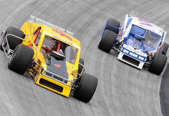 BRISTOL, TN - AUGUST 19:  Donny Lia driver of the #4 Mystic Missile Dodge race with Richard Savary driver of the #21 Alloy Wheel Repair Chevrolet duirng the NASCAR Whelen Modified Tour at Bristol Motor Speedway on August 19, 2009 in Bristol, Tennessee.  (Photo by John Harrelson/Getty Images for NASCAR)