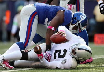 EAST RUTHERFORD, NJ - OCTOBER 11:  Justin Tuck #91 of the New York Giants sacks JaMarcus Russell #2 of the Oakland Raiders in the third quarter on October 11, 2009 at Giants Stadium in East Rutherford, New Jersey. The Giants defeated the Raiders 44-7.  (Photo by Jim McIsaac/Getty Images)