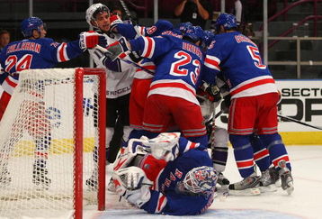 NEW YORK - OCTOBER 14: Anze Kopitar #11 of the Los Angeles Kings is pushed out of the crease after a collision knocked down Henrik Lundqvist #30 of the New York Rangers at Madison Square Garden on October 14, 2009 in New York, New York. (Photo by Bruce Bennett/Getty Images)