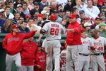 BOSTON - OCTOBER 11:  Juan Rivera #20 of the Los Angeles Angels of Anaheim is greeted at the dugout by manager Mike Scioscia and teammates after Rivera hit a two-run single in the eighth inning against the Boston Red Sox in Game Three of the ALDS during the 2009 MLB Playoffs at Fenway Park on October 11, 2009 in Boston,  Massachusetts. (Photo by Jim Rogash/Getty Images)