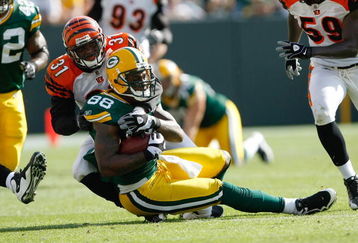 GREEN BAY, WI - SEPTEMBER 20: Tight end Jermichael Finley #88 of the Green Bay Packers is tackled by defensive back Roy Williams #31 of the Cincinnati Bengals at Lambeau Field on September 20, 2009 in Green Bay, Wisconsin. The Bengals defeated the Packers 31-24. (Photo by Scott Boehm/Getty Images)