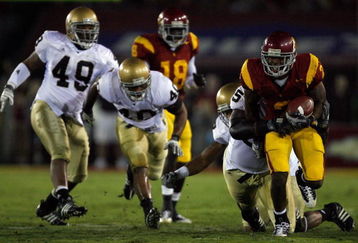 LOS ANGELES, CA - NOVEMBER 29:  C.J. Gable #2 of the USC Trojans tries to break from the Notre Dame Fighting Irish defense during the quarter at the Coliseum on November 29, 2008 in Los Angeles, California.  (Photo by Harry How/Getty Images)