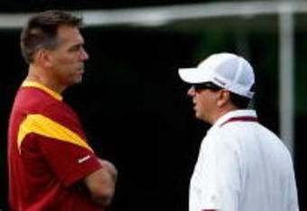 ASHBURN, VA - JULY 30:  Washington Redskins Head Coach Jim Zorn (C) talks with owner Daniel Snyder (R) as Executive Vice President for Football Operations Vinny Cerrato (L) looks on during the first day of training camp July 30, 2009 in Ashburn, Virginia.  (Photo by Win McNamee/Getty Images)