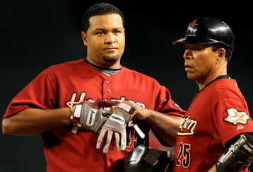 PHOENIX - AUGUST 29:  Carlos Lee #45 of the Houston Astros reacts with coach Jose Cruz after hitting a fly ball out against the Arizona Diamondbacks during the major league baseball game at Chase Field on August 29, 2009 in Phoenix, Arizona. The Diamondbacks defeated the Astros 9-0. (Photo by Christian Petersen/Getty Images)
