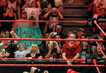 LAS VEGAS - AUGUST 24:  Wrestler Evan Bourne jumps off the ropes at wrestler Chavo Guerrero (C) as wrestler Hornswoggle lies in the foreground during the WWE Monday Night Raw show at the Thomas & Mack Center August 24, 2009 in Las Vegas, Nevada.  (Photo by Ethan Miller/Getty Images)
