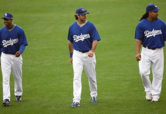 LOS ANGELES - OCTOBER 14:  (L-R) Juan Pierre #9, Andre Ethier #16, and Manny Ramirez #99 of the Los Angeles Dodgers walk in the outfield as they work out for the NLCS against the Philadelphia Phillies on October 14, 2009 at Dodger Stadium in Los Angeles, California.  (Photo by Stephen Dunn/Getty Images)