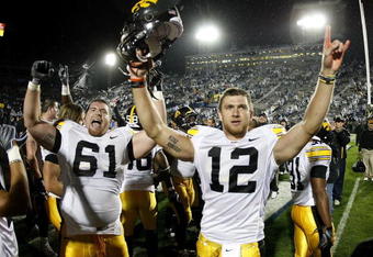 STATE COLLEGE, PA - SEPTEMBER 26:  Ricky Stanzi #12 of the Iowa Hawkeyes celebrates a 21-10 victory over the Penn State Nittnay Lions with Travis Meade #61 on September 26, 2009 at Beaver Stadium in State College, Pennsylvania.  (Photo by Gregory Shamus/Getty Images)