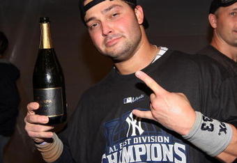 NEW YORK - SEPTEMBER 27:  Nick Swisher #33 of the New York Yankees celebrates in the clubhouse after his team defeated the Boston Red Sox on September 27, 2009 at Yankee Stadium in the Bronx borough of New York City. The Yankees won the game 4-2 to earn their 100th win of the season as well as clinching the American League Eastern Division.  (Photo by Jim McIsaac/Getty Images)