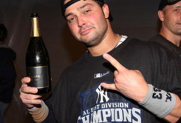 NEW YORK - SEPTEMBER 27:  Nick Swisher #33 of the New York Yankees celebrates in the clubhouse after his team defeated the Boston Red Sox on September 27, 2009 at Yankee Stadium in the Bronx borough of New York City. The Yankees won the game 4-2 to earn their 100th win of the season as well as clinching the American League Eastern Division.  (Photo by Jim McIsaac/Getty Images)
