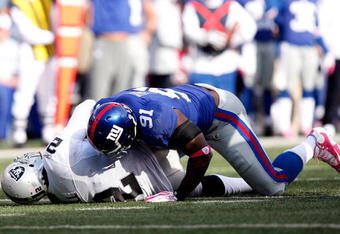 EAST RUTHERFORD, NJ - OCTOBER 11:  Justin Tuck #91 of the New York Giants sacks JaMarcus Russell #2 of the Oakland Raiders during the game on October 11, 2009 at Giants Stadium in East Rutherford, New Jersey.  (Photo by Jared Wickerham/Getty Images)