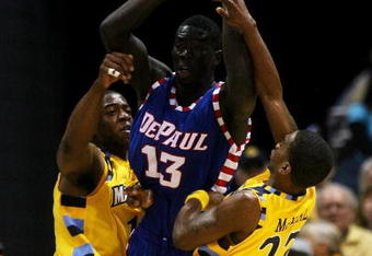 MILWAUKEE - JANUARY 24: Dwight Burke #12 (L) and Jerel McNeal #22 of the Marquette Golden Eagles trap Mac Koshwal #13 of the DePaul Blue Demons on March 24, 2009 at the Bradley Center in Milwaukee, Wisconsin. Marquette defeated DePaul 79-70. (Photo by Jonathan Daniel/Getty Images)