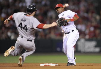 ANAHEIM, CA - OCTOBER 08:   Howie Kendrick #47 of the Los Angeles Angels of Anaheim turns a double play on Jason Bay #44 at of the Boston Red Sox at second the throws to first base to get Mike Lowell #25 in  in Game One of the ALDS during the 2009 MLB Playoffs at Angel Stadium on October 8, 2009 in Anaheim, California.  (Photo by Kevork Djansezian/Getty Images)