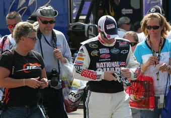 BROOKLYN, MI - AUGUST 14:  Dale Earnhardt Jr.,  driver of the #88 National Guard/AMP Energy Chevrolet signs aoutographs for fans, during practice for the NASCAR Sprint Cup Series Michigan 400 at Michigan Internetional Speedway on August 14, 2009 in Brooklyn, Michigan.  (Photo by Jerry Markland/Getty Images for NASCAR)