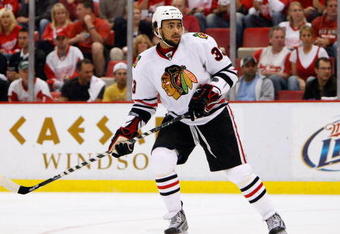 DETROIT - MAY 27:  Dustin Byfuglien #33 of the Chicago Blackhawks skates against the Detroit Red Wings during Game Five of the Western Conference Championship Round of the 2009 Stanley Cup Playoffs on May 27, 2009 at Joe Louis Arena in Detroit, Michigan. The Red Wings won 2-1 in overtime.  (Photo by Gregory Shamus/Getty Images)