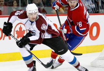 MONTREAL- OCTOBER 15:  Kyle Cumiskey #10 of the Colorado Avalanche stick handles the puck while being chased by Kyle Chipchura #28 during the NHL game on October 15, 2009 at the Bell Centre in Montreal, Quebec, Canada.  The Avalanche defeated the Canadiens 3-2.  (Photo by Richard Wolowicz/Getty Images)