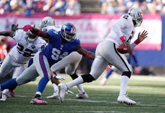 EAST RUTHERFORD, NJ - OCTOBER 11: JaMarcus Russell #2 of the Oakland Raiders is chased by Mathias Kiwanuka #94 of the New York Giants during the game on October 11, 2009 at Giants Stadium in East Rutherford, New Jersey. (Photo by Jared Wickerham/Getty Images)