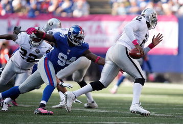 EAST RUTHERFORD, NJ - OCTOBER 11: JaMarcus Russell #2 of the Oakland Raiders is chased by Mathias Kiwanuka #94 of the New York Giants during the game on October 11, 2009 at Giants Stadium in East Rutherford, New Jersey. (Photo by Jared Wickerham/Getty Images)