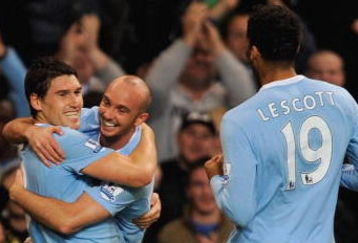 MANCHESTER, ENGLAND - SEPTEMBER 23: Gareth Barry of Manchester City celebrates scoring the equaliser to make it 1-1 with Stephen Ireland and Joleon Lescott during the Carling Cup third round match between Manchester City and Fulham at the City of Manchester Stadium on September 23, 2009 in Manchester, England.  (Photo by Michael Regan/Getty Images)