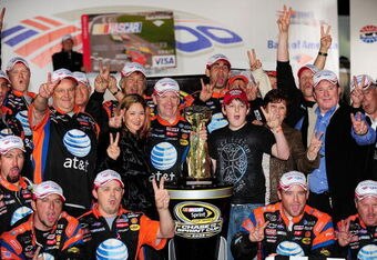 CONCORD, NC - OCTOBER 11:  Jeff Burton, driver of the #31 AT&T Mobility Chevrolet, and the AT&T Mobility team celebrate in victory lane after winning the NASCAR Sprint Cup Series Bank of America 500 at Lowe's Motor Speedway on October 11, 2008 in Concord, North Carolina.  (Photo by Rusty Jarrett/Getty Images for NASCAR)