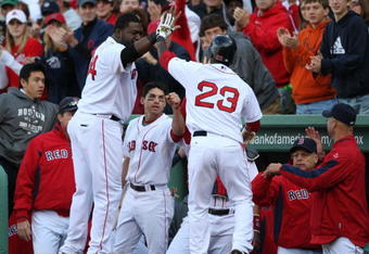 BOSTON - OCTOBER 11:  Joey Gathright #23 of the Boston Red Sox is celebrates with teammate David Ortiz #34 after scoring on a RBI single by Mike Lowell #25 in the eighth inning of Game Three of the ALDS against the Los Angeles Angels of Anaheim during the 2009 MLB Playoffs at Fenway Park on October 11, 2009 in Boston, Massachusetts. (Photo by Elsa/Getty Images)