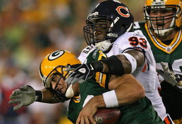GREEN BAY, WI - SEPTEMBER 13: Aaron Rodgers #12 of the Green Bay Packers is sacked by Adewale Ogunleye #93 of the Chicago Bears on September 13, 2009 at Lambeau Field in Green Bay, Wisconsin. (Photo by Jonathan Daniel/Getty Images)