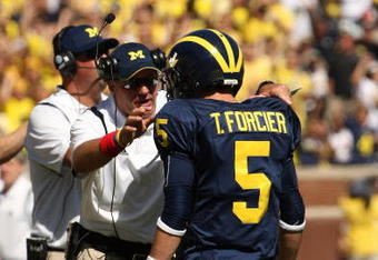 ANN ARBOR, MI - SEPTEMBER 19:  Head coach Rich Rodriguez of the Michigan Wolverines talks with quarterback Tate Forcier #5 during the game with the Eastern Michigan Eagles at Michigan Stadium on September 19, 2009 in Ann Arbor, Michigan.  Michigan won 45-17.  (Photo by Stephen Dunn/Getty Images)